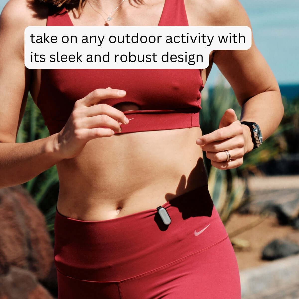 Woman in red sports outfit wearing sun-a-wear UV tracker on her hip while running outside on a hot summer day, take on any outdoor activity with its sleek and roust design